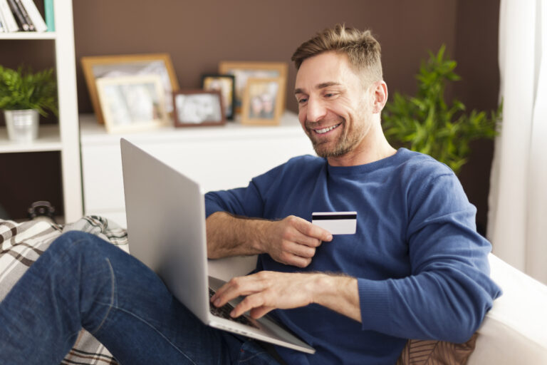 The Power of DAM for Retail 2 smiling man online shopping home