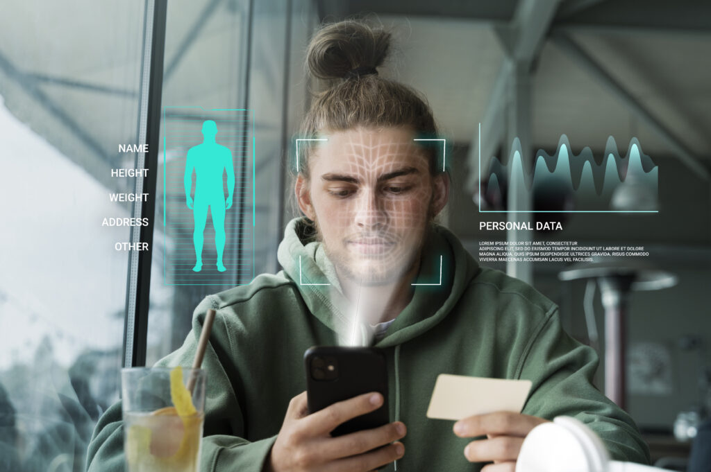Young man with holographics representing face recognition and customer data to drive customer engagement