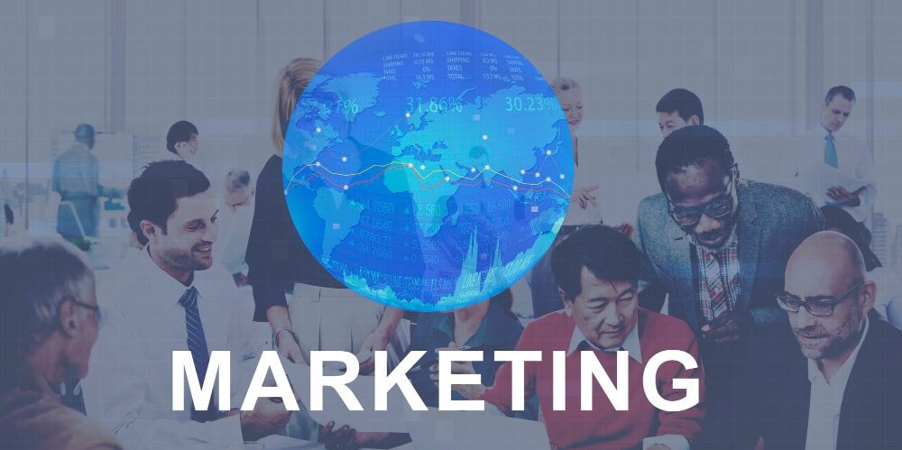 Image of a globe above the word "marketing." The background shows a marketing team collaborating on brand standards, highlighting how brand governance tools enable global teams.